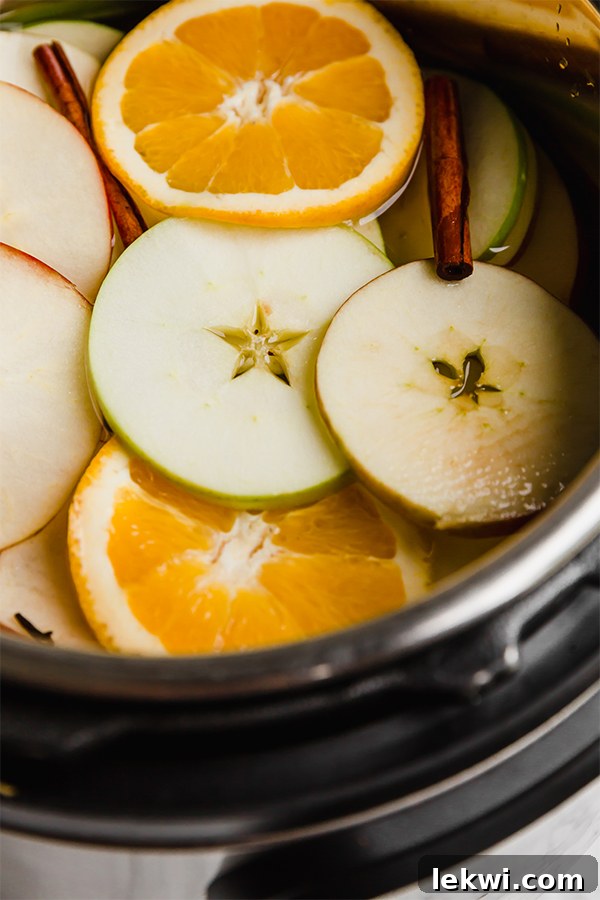 A top-down view of the Instant Pot filled with ingredients for apple cider, illustrating the simple preparation process.