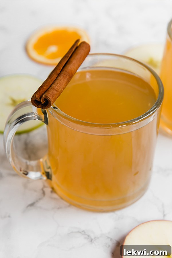 Close-up of the Instant Pot containing apples, oranges, and spices, illustrating the fresh ingredients before cooking.