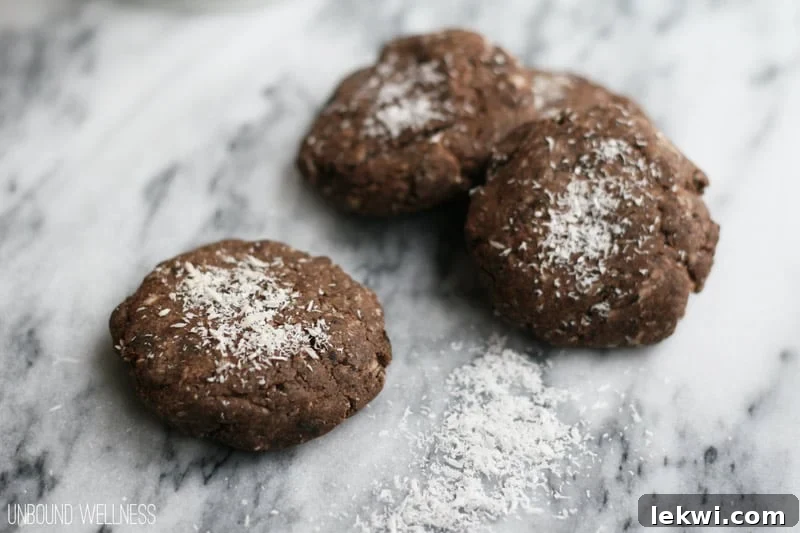 Close-up of baked Paleo AIP "Chocolate" Snowflake Christmas Cookies with coconut flakes