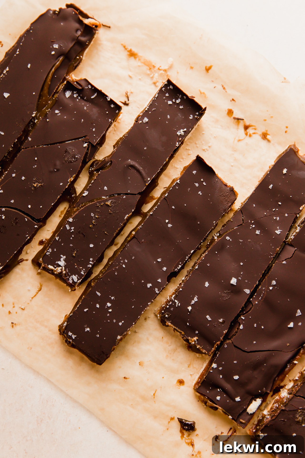 Sliced Twix bars artfully arranged on a piece of parchment paper.
