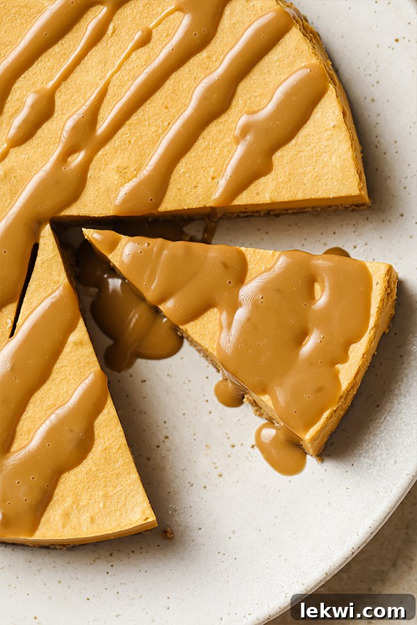 Slices of salted caramel pumpkin cheesecake artfully arranged on a plate, each topped with a luscious caramel drizzle.