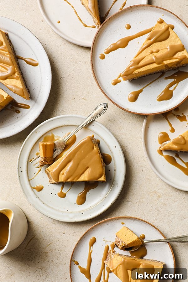 Several plates with slices of salted caramel pumpkin cheesecake, perfectly drizzled with caramel.