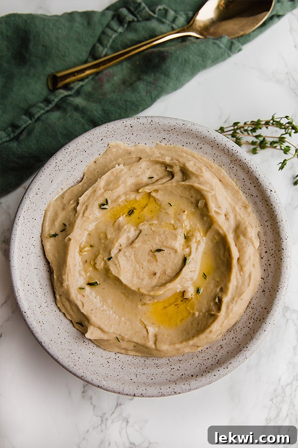 A close-up of roasted cauliflower and parsnip mash in a bowl, showing its creamy texture.