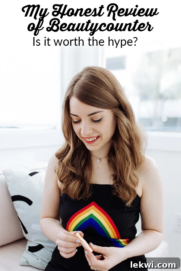 Michelle wearing a black tank top with rainbow on it looking down.