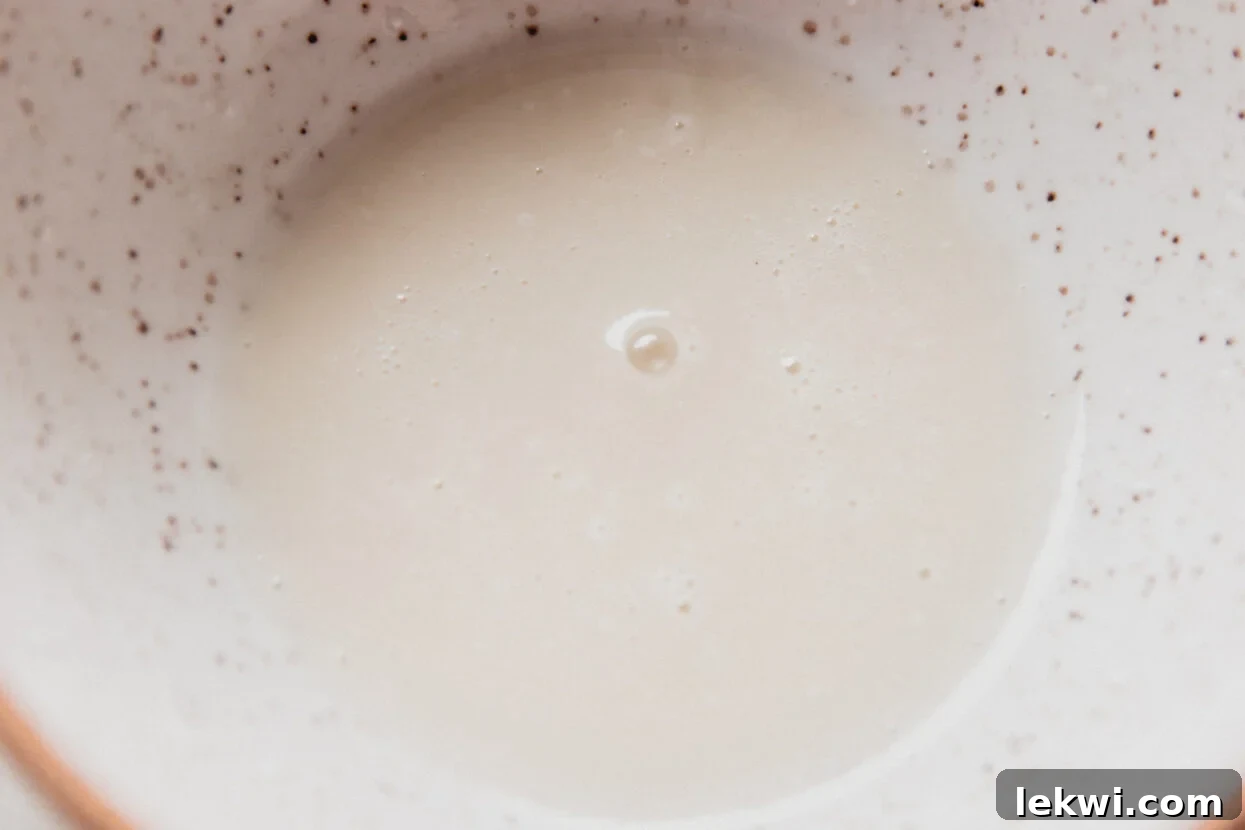 Spritz cookie white icing in a bowl.