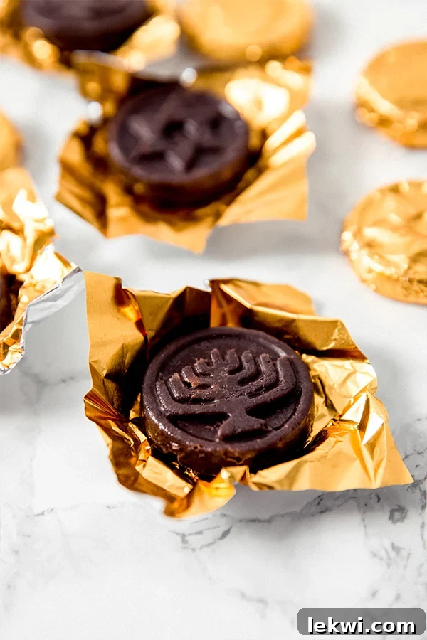 A small collection of shiny gold-wrapped gelt pieces, reminiscent of chocolate coins, inviting a sense of festive celebration.