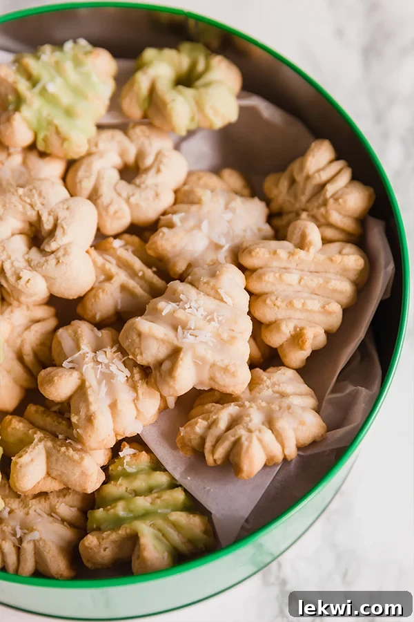 A green tin filled with homemade spritz cookies.