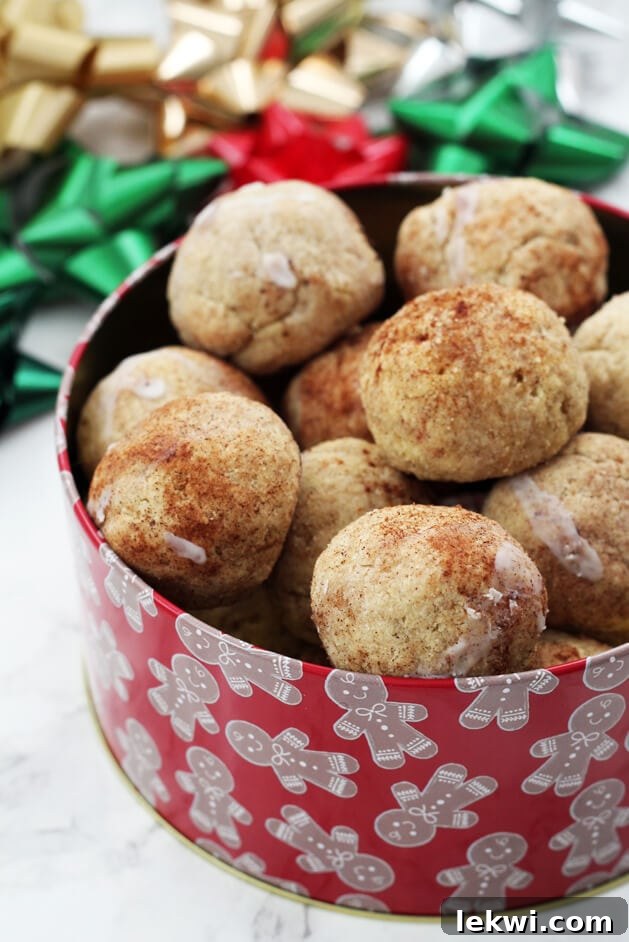 A red tin filled with homemade donut holes in it.
