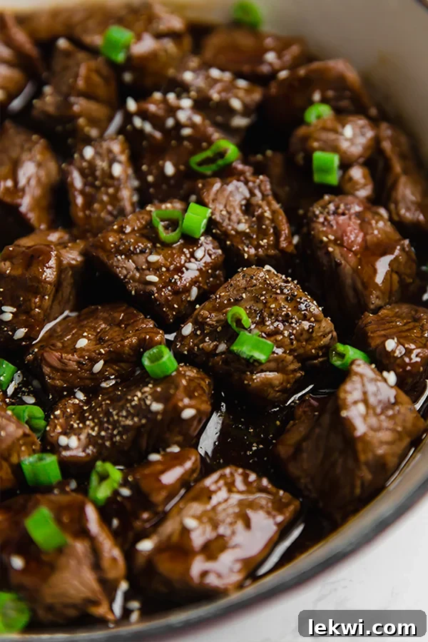A close-up shot of perfectly cooked teriyaki steak bites, beautifully glazed and ready to be served.