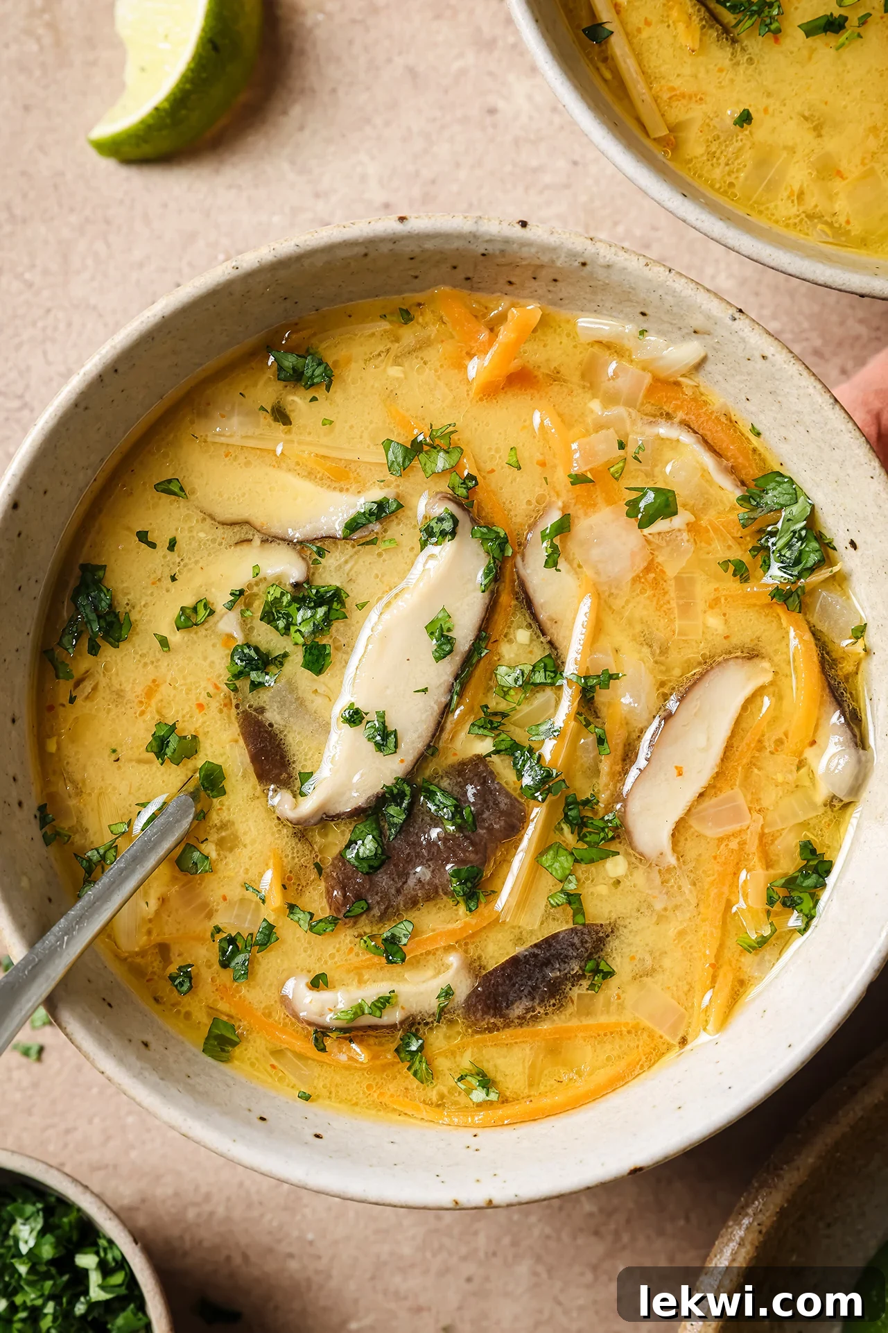 Tom kha soup with a spoon.