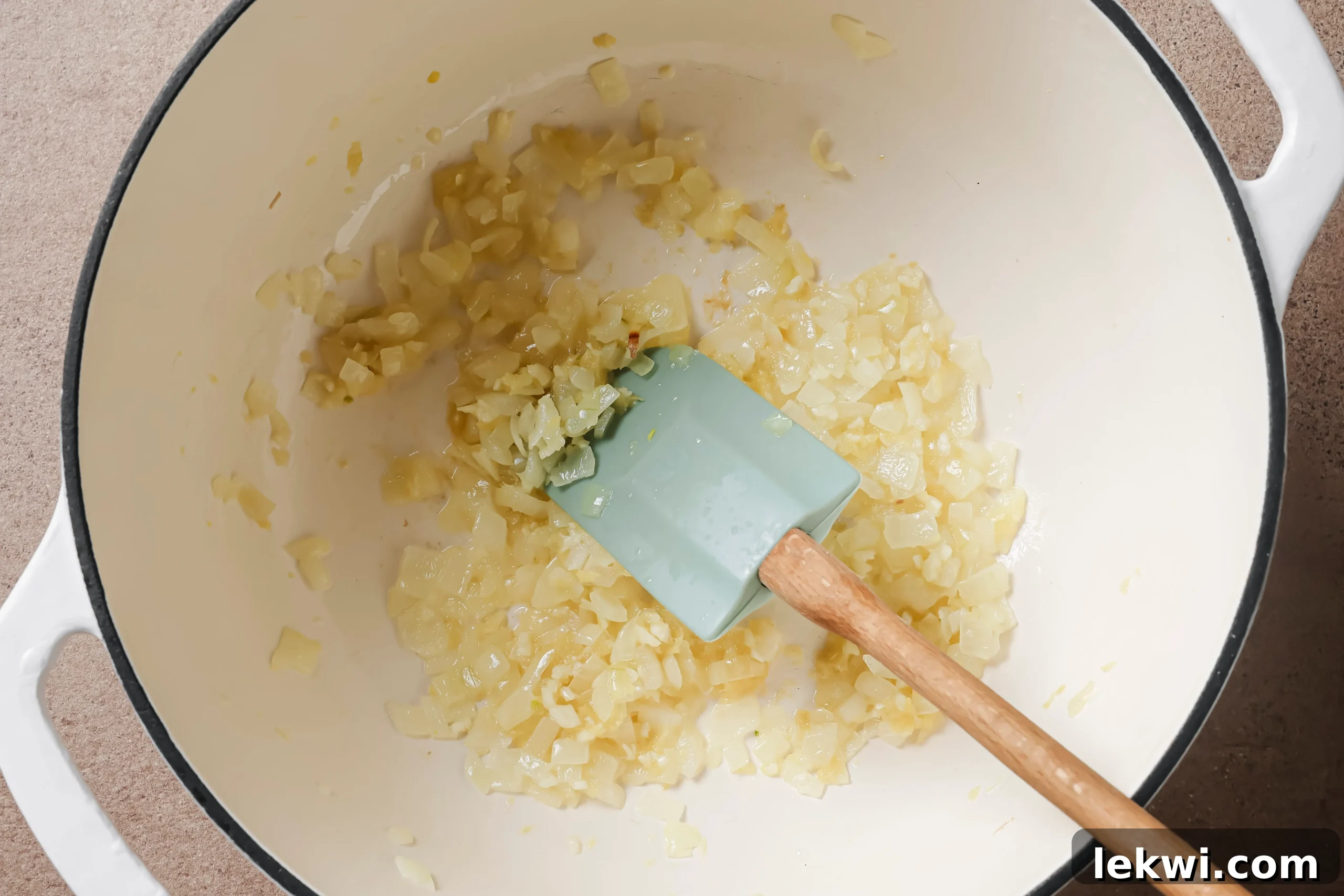 Onion sauteing in a pot.