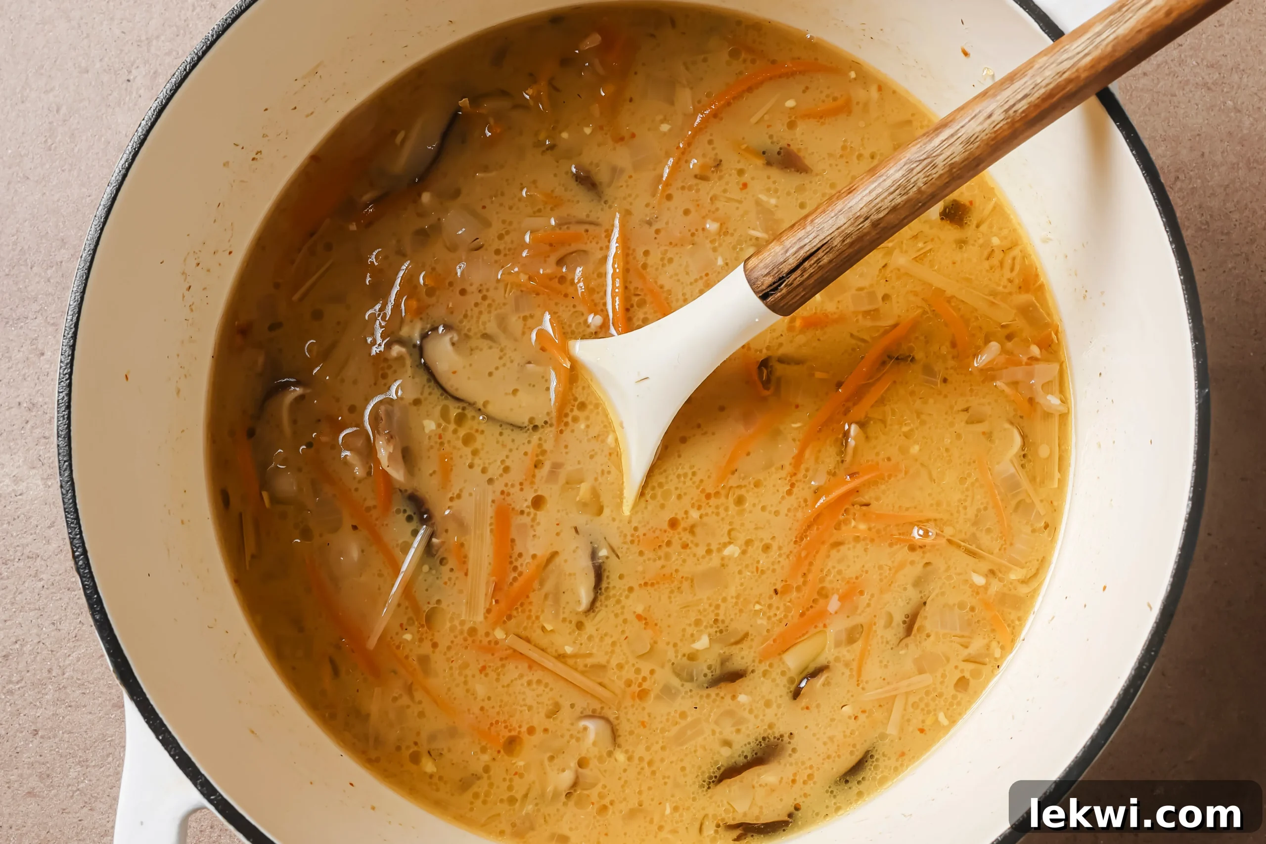 Tom kha soup fully cooked in a pot.
