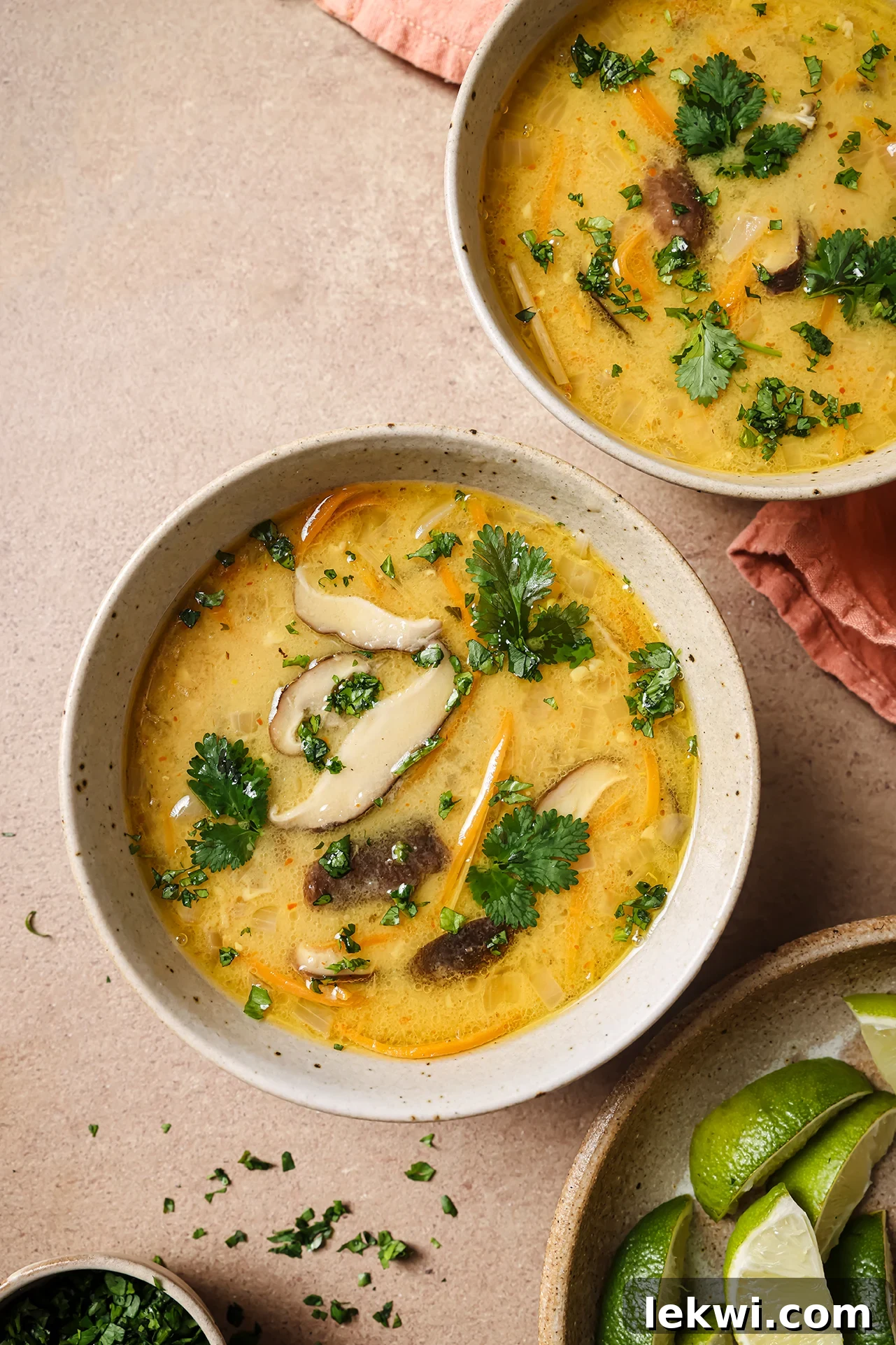 Tom Kha Soup in two bowls topped with cilantro.