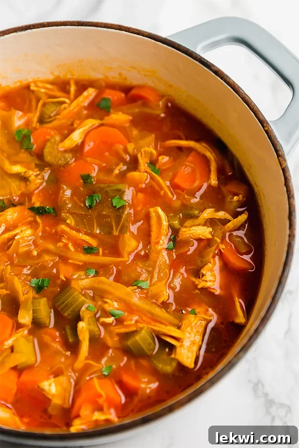 A Dutch oven filled with anti-inflammatory turmeric cabbage soup after cooking.