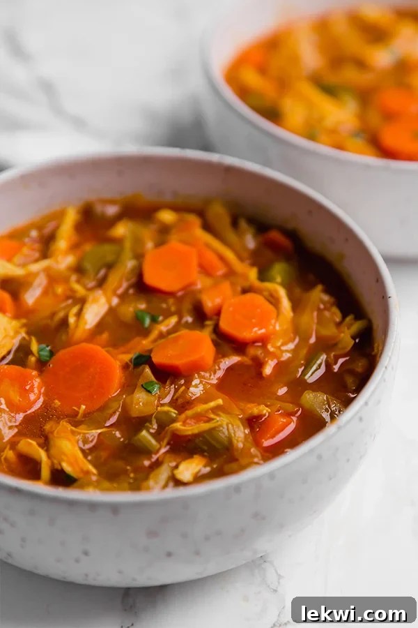 A bowl filled with anti-inflammatory turmeric cabbage soup after cooking.