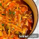 A Dutch oven filled with anti-inflammatory turmeric cabbage soup after cooking.