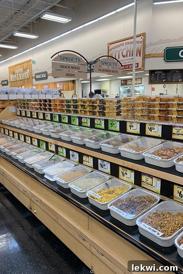 A close-up view of Sprouts' bulk bins, showcasing an assortment of nuts, seeds, and dried goods, emphasizing options for sustainable and budget-conscious shopping.