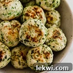 A bowl filled with Mediterranean veggie & chicken meatballs.