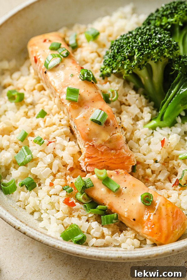 bang bang salmon in a bowl cut in half.