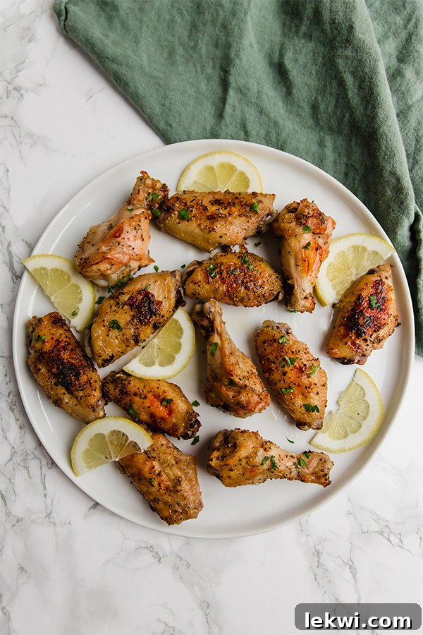 A close-up shot of golden, crispy lemon pepper chicken wings on a plate, ready to be enjoyed.