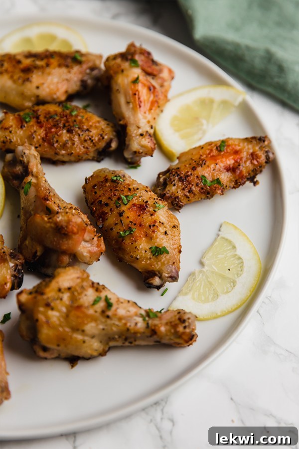 A vibrant close-up of crispy lemon pepper chicken wings, perfectly seasoned and ready to enjoy.