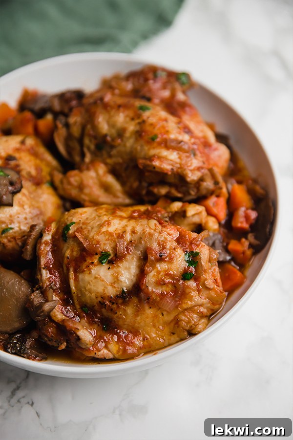 A serving bowl filled with slow cooker chicken cacciatore.