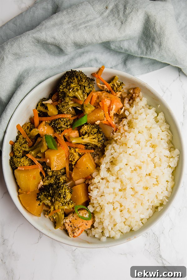 A close-up of a serving of Hawaiian Chicken in a bowl, showcasing the succulent chicken, vibrant pineapple, and colorful vegetables, ready to be enjoyed.