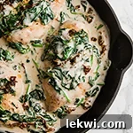 A pan with Tuscan chicken skillet after it has finished cooking.