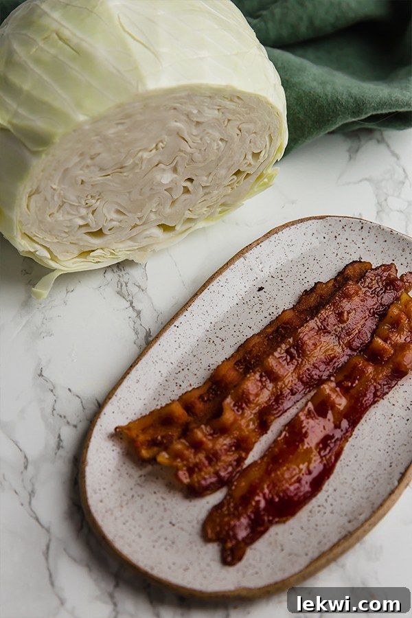 Two roasted cabbage steaks on a wooden board, garnished with chopped parsley.