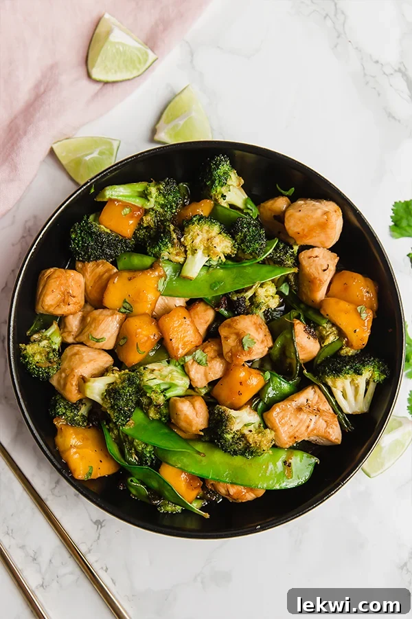 A second view of the mango chicken stir fry, showcasing its colorful ingredients and rich sauce.