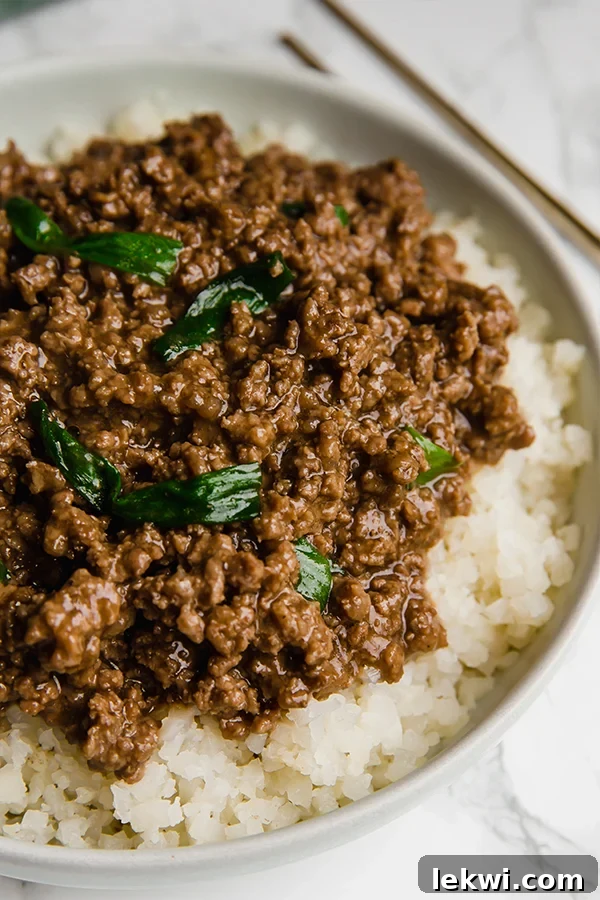 A bowl filled with cauliflower rice topped with Mongolian ground beef.