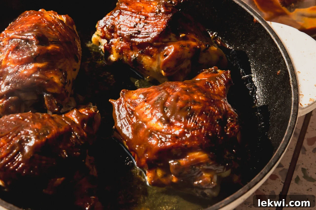 BBQ chicken thighs in a cast iron pan.