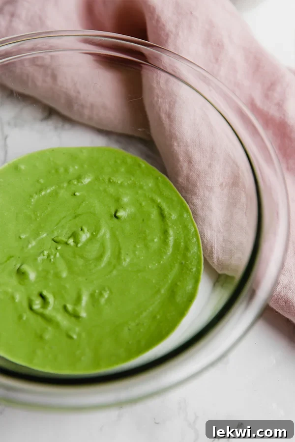 A close-up of whipped matcha in a bowl, showcasing its creamy, airy texture.