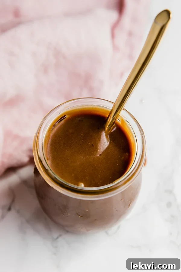 Close-up of a jar filled with creamy Paleo Dulce de Leche, ready to be enjoyed