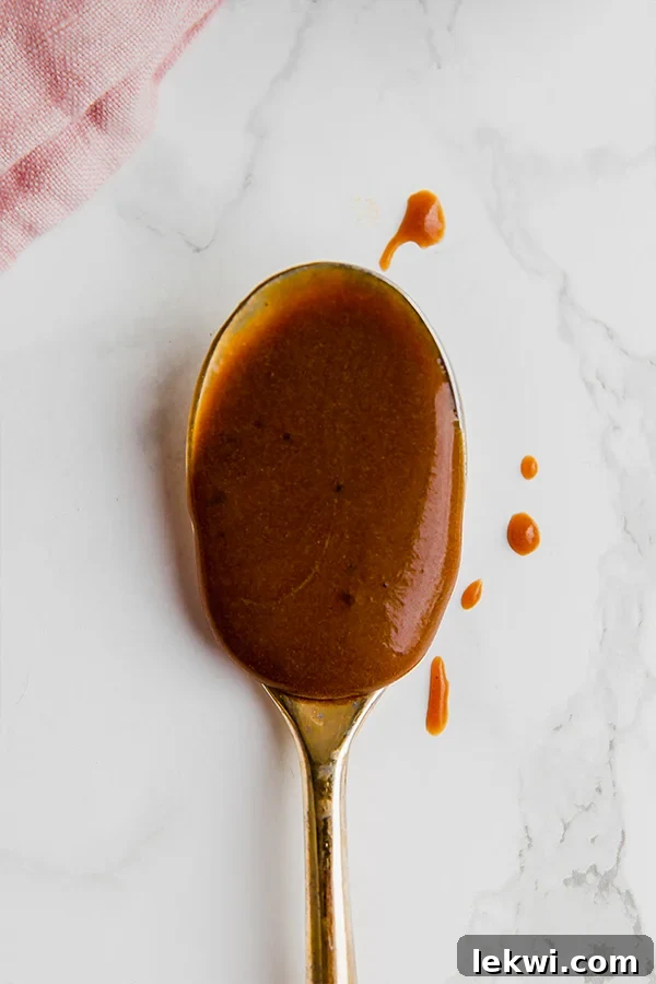A bowl of fresh fruit with a generous drizzle of homemade Paleo Dulce de Leche