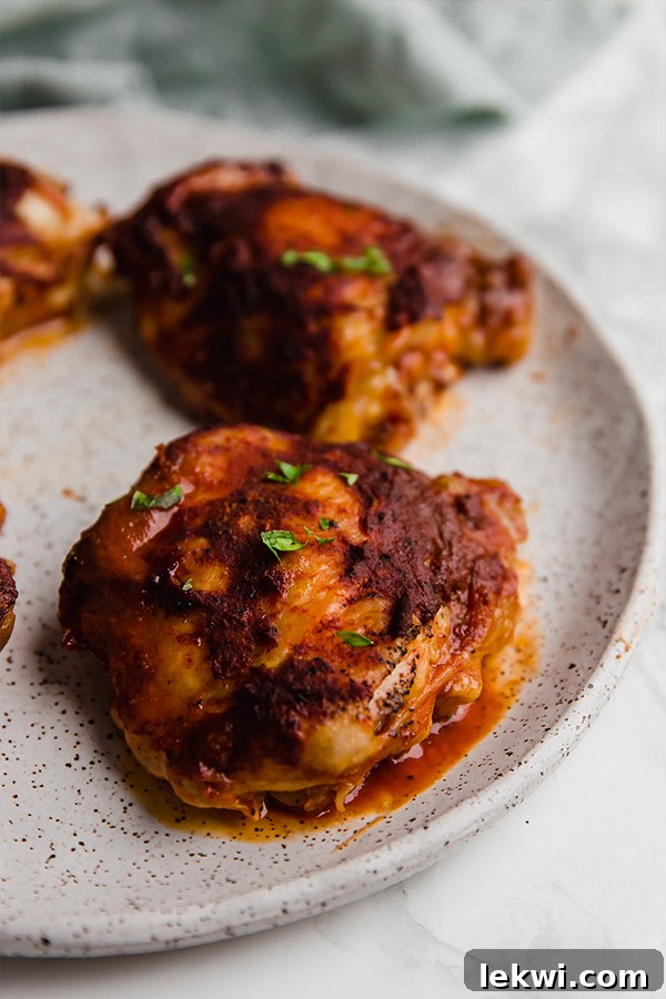 Oven baked BBQ chicken thighs in a casserole dish, fresh out of the oven.