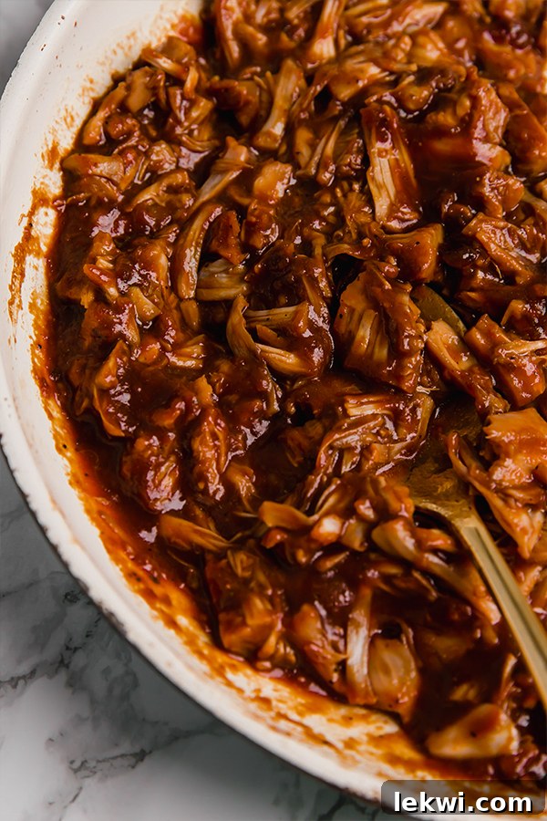 A serving bowl filled with BBQ jackfruit topped.