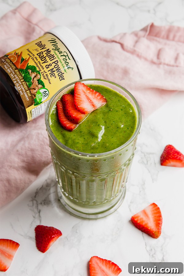 Green Mama Smoothie in a glass, packed with nutrients for supporting moms, featuring spinach, mango, and berries for a dairy-free powerhouse blend.