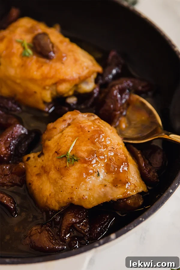 honey balsamic apricot chicken thighs in a black pan.