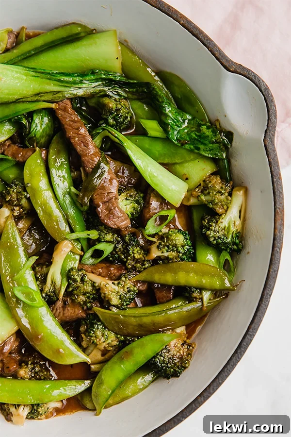 A baking dish filled with ginger beef stir fry after cooking.