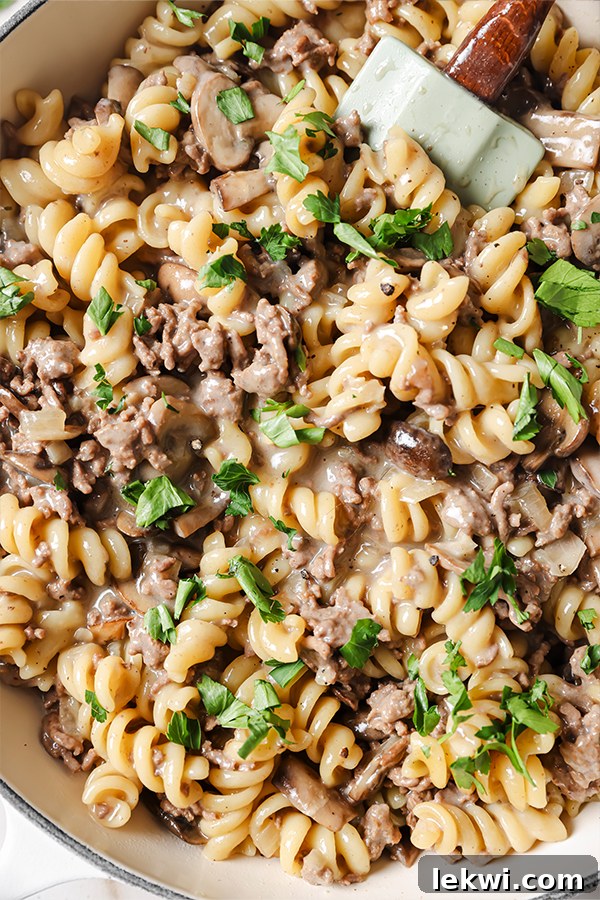 A close-up view of a pot filled with creamy homemade beef stroganoff hamburger helper, showcasing its rich texture and ingredients.