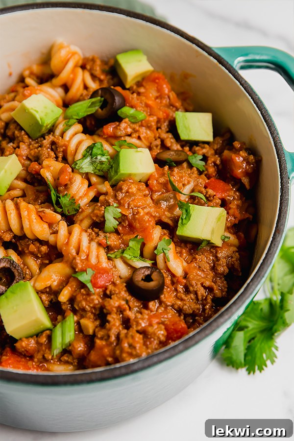 A large Dutch oven filled with savory paleo taco pasta, ready to be served.