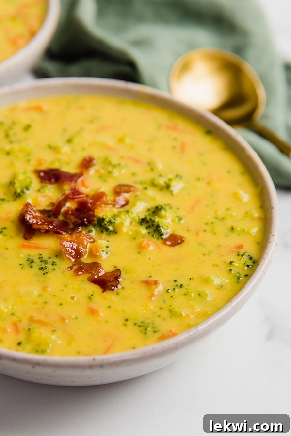 Bowl of dairy-free broccoli cheese soup garnished with fresh parsley.