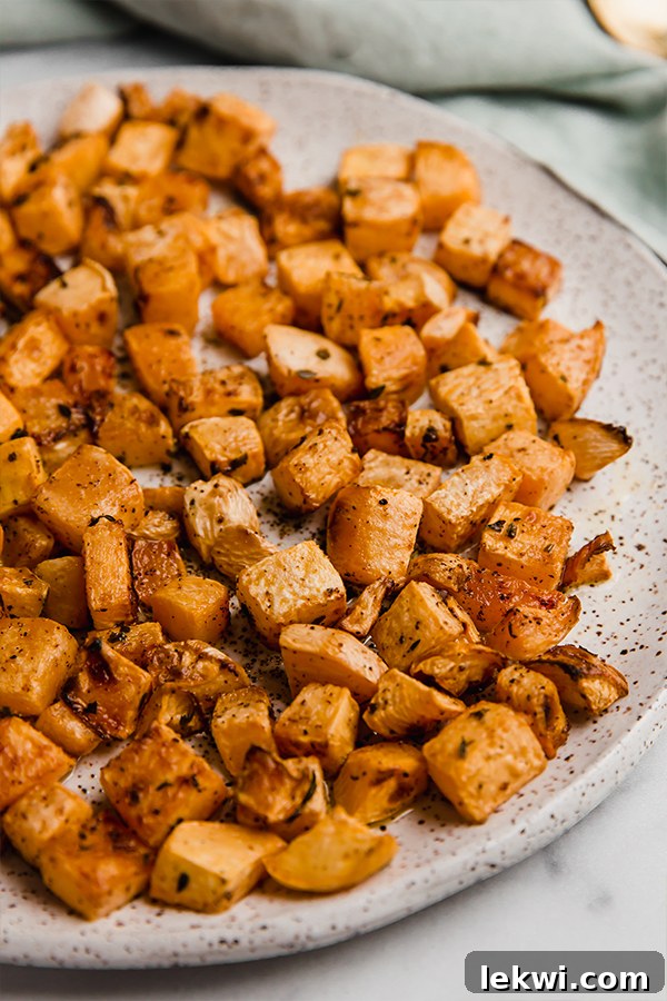 Close-up of perfectly roasted rutabaga, showing its golden-brown edges and tender interior, inviting a taste.