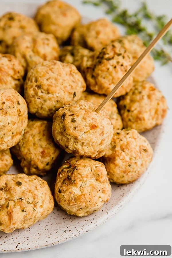 Delicious Paleo Sausage Balls arranged on a festive serving platter with toothpicks, perfect for holiday gatherings.