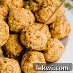 A vibrant platter overflowing with freshly baked paleo sausage balls, ready for guests.