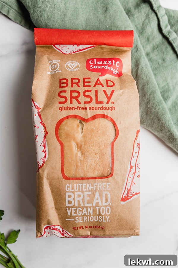 A whole loaf of gluten-free sourdough bread, ready to be sliced for Texas toast.