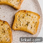 A speckled plate with three slices of gluten free texas toast.