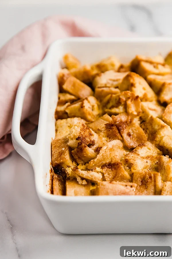 Golden brown gluten-free french toast casserole in a baking dish, with bread cubes visible.