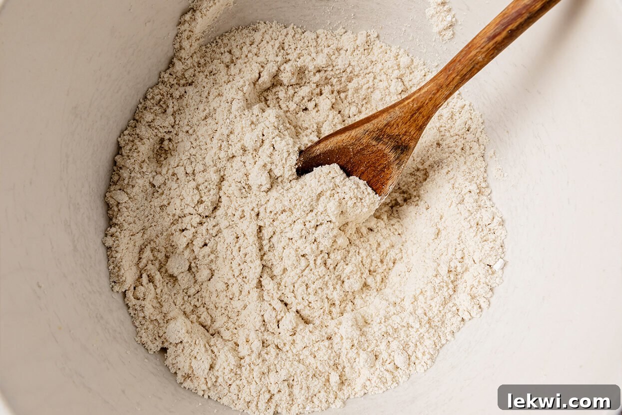 Dry ingredients for snickerdoodle cookies, including tigernut flour and tapioca starch, sifted together in a mixing bowl.